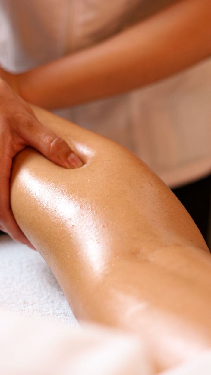 gallery-1 Close-up of a relaxing leg massage in a spa, highlighting wellness and relaxation.