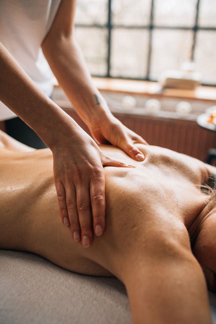 gallery-2 A calming body massage session in a serene spa room for ultimate relaxation and self-care.